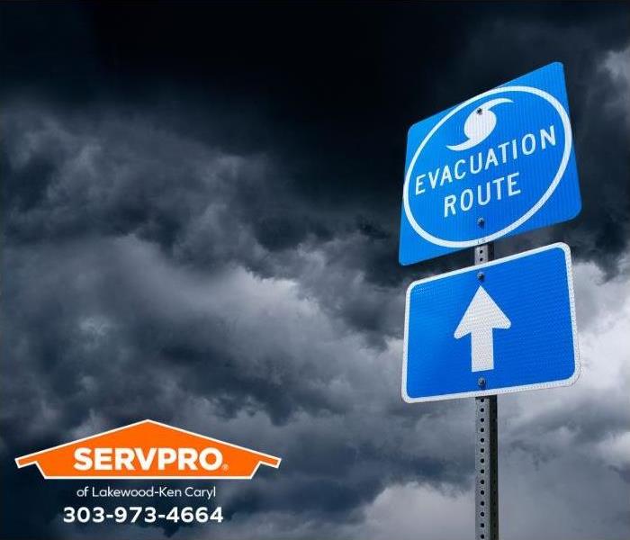 As a storm threatens, an evacuation route sign points the way.