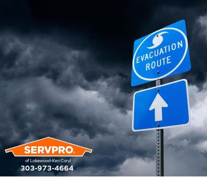 As a storm threatens, an evacuation route sign points the way.