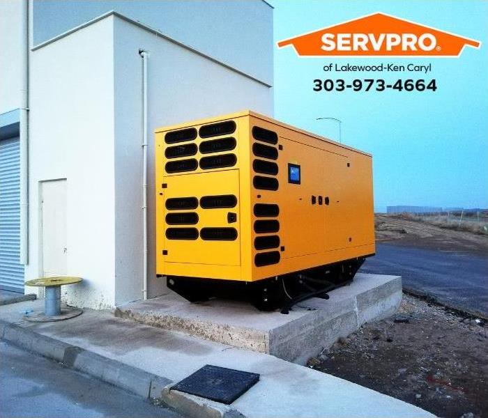 A commercial generator is secured next to a commercial property.