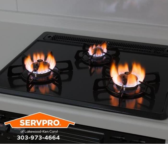 The gas burners on a stovetop are lit and left unattended.